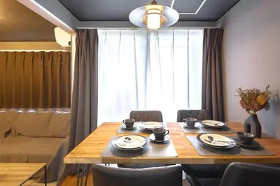 a dining room with a wooden table and chairs at Sumu Hotel Shinjuku in Tokyo