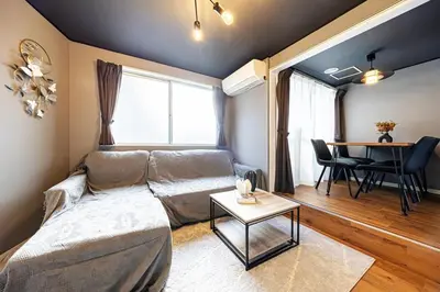 a living room with a couch and a table at Sumu Hotel Shinjuku in Tokyo
