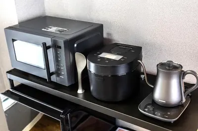 a microwave and a coffee pot on a table at Sumu Hotel Shinjuku in Tokyo