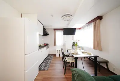 a kitchen and dining room with a table and chairs at Tokyo RIRIARU HOTEL \u65b0\u5fa1\u5f92\u753a in Tokyo