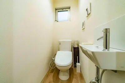a bathroom with a white toilet and a sink at Kokoon Hotel Kitashinjuku in Tokyo