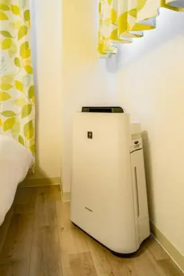 a small refrigerator in a corner of a room at Kokoon Hotel Kitashinjuku in Tokyo