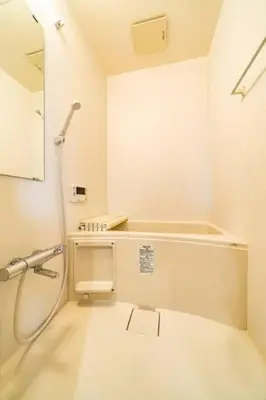 a white bathroom with a shower and a sink at Kokoon Hotel Kitashinjuku in Tokyo