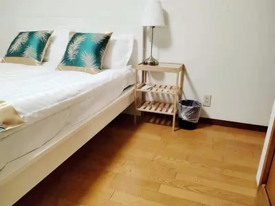 a bedroom with a bed with a night stand next to it at \u70df\u96e8\u8f69201 in Tokyo