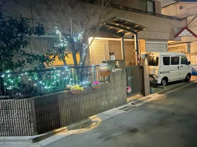 a white van parked in front of a house with lights at \u70df\u96e8\u8f69201 in Tokyo