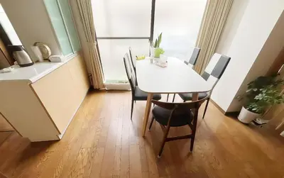 a dining room with a white table and chairs at \u70df\u96e8\u8f69201 in Tokyo