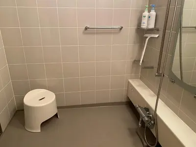 a bathroom with a toilet and a shower and a sink at S & K Garden House in Tokyo