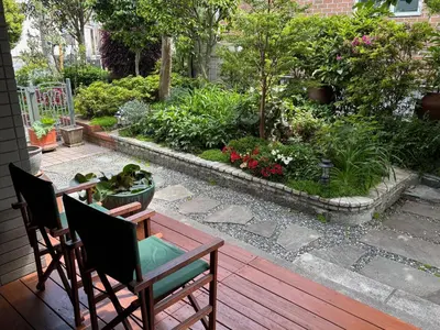 a patio with two chairs and a table and a garden at S & K Garden House in Tokyo