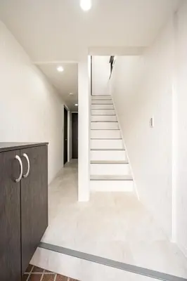 an empty hallway with stairs in a house at Kokoon Hotel Yahiro in Tokyo