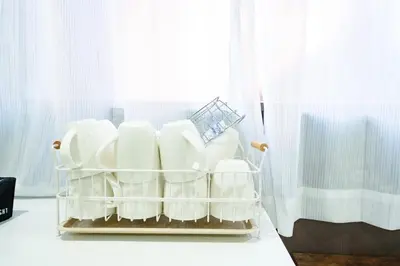 a basket of dishes sitting on a shelf next to a window at Kokoon Hotel Yahiro in Tokyo