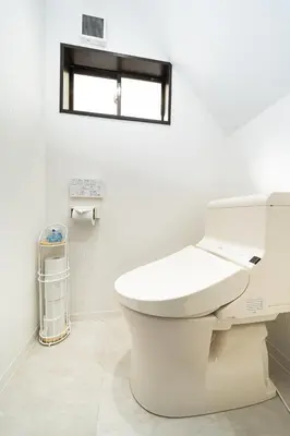 a white bathroom with a toilet and a window at Kokoon Hotel Yahiro in Tokyo