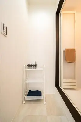 a hallway with a towel rack in a room at Kokoon Hotel Yahiro in Tokyo