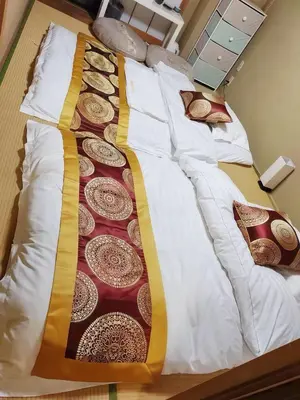 a bed with white sheets and pillows on it at \u70df\u96e8\u8f69 202 in Tokyo