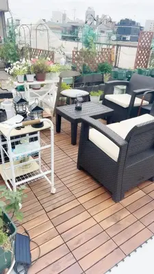 a patio with couches and tables on a roof at \u70df\u96e8\u8f69 202 in Tokyo