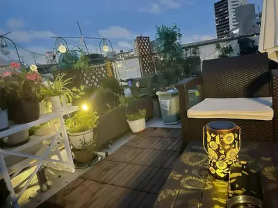 a balcony with a table and potted plants on it at \u70df\u96e8\u8f69 202 in Tokyo