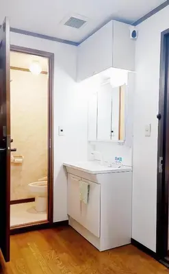 a white bathroom with a toilet and a sink at \u70df\u96e8\u8f69 203 in Tokyo
