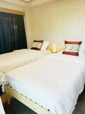 two beds sitting next to each other in a room at \u70df\u96e8\u8f69 303 in Tokyo