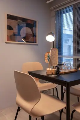 a dining room with a black table and chairs at Mi-HOTEL OTSUKA in Tokyo