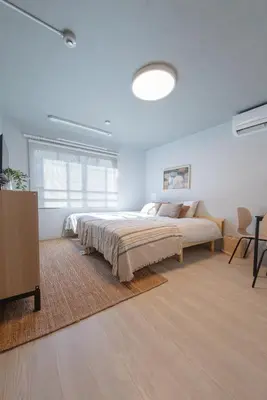 a bedroom with a bed and a dresser in it at Mi-HOTEL OTSUKA in Tokyo