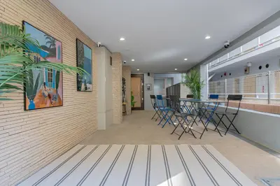 a lobby with a table and chairs on a wall at Mi-HOTEL OTSUKA in Tokyo