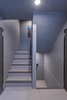 a staircase in a building with stairs leading up at Mi-HOTEL OTSUKA in Tokyo