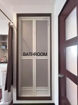 a door with the word bathroom written on it at Ueno Sakura House in Tokyo