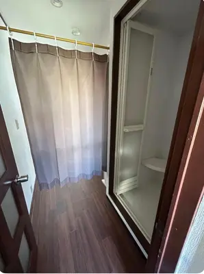 a bathroom with a shower with a glass door at Ueno Sakura House in Tokyo