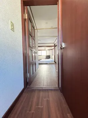 an open door to a hallway with a bed at Ueno Sakura House in Tokyo