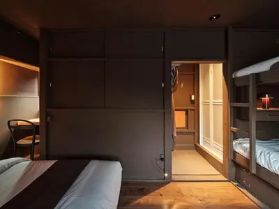a room with two bunk beds and a room with a bed at Tokyo Skyline Hideaway in Tokyo