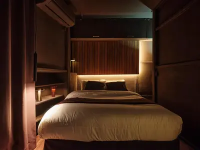 a bedroom with a large bed in a dark room at Tokyo Skyline Hideaway in Tokyo