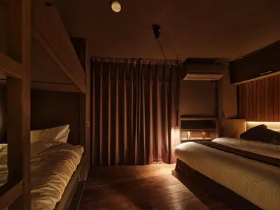 a bedroom with two beds and a curtain at Tokyo Skyline Hideaway in Tokyo