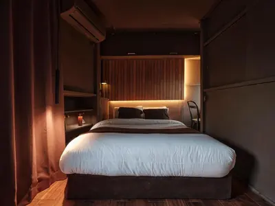 a bedroom with a large bed with lights on it at Tokyo Skyline Hideaway in Tokyo