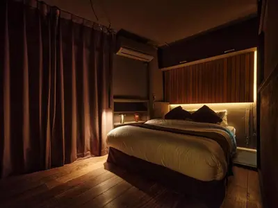 a bedroom with a bed in a room with a window at Tokyo Skyline Hideaway in Tokyo