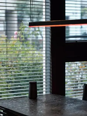 a table in front of a window with blinds at Tokyo Skyline Hideaway in Tokyo