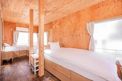 a bedroom with two bunk beds and a window at Screamer 2 Hostel in Tokyo