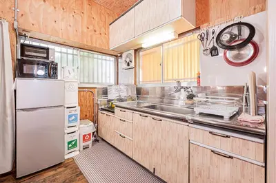 a kitchen with a white refrigerator and a sink at Screamer 2 Hostel in Tokyo