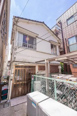 a house with a garage in front of it at Screamer 2 Hostel in Tokyo
