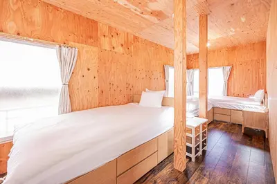 a bedroom with two beds in a wooden cabin at Screamer 2 Hostel in Tokyo
