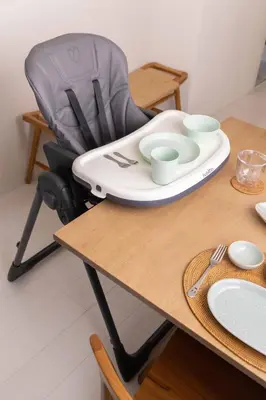 a table with a high chair with a plate on it at Cloud Nine Apartment Sky Tree in Tokyo