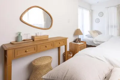 a bedroom with a mirror on a dresser and a bed at Cloud Nine Apartment Sky Tree in Tokyo