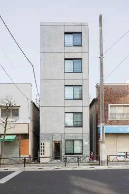 a tall gray building on a city street at Cloud Nine Apartment Sky Tree in Tokyo