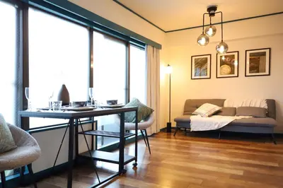 a living room with a table and a couch at \u30b9\u30bf\u30fc\u30cf\u30a4\u30c4\u84b2\u7530301 in Tokyo