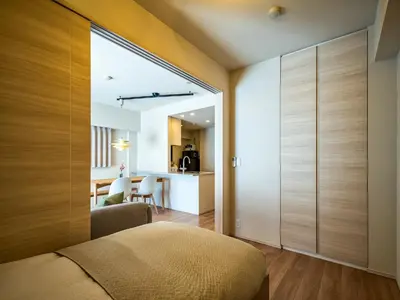 a bedroom with a large glass door leading to a kitchen at Section L Residence Shibuya in Tokyo