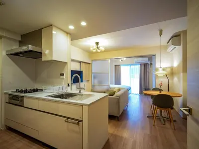 a kitchen and living room with a couch and a table at Section L Residence Shibuya in Tokyo