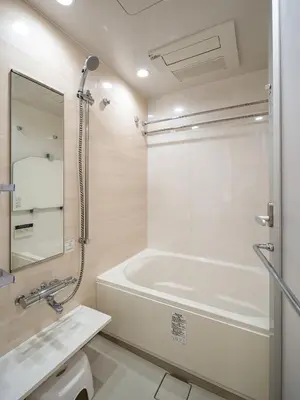a white bathroom with a tub and a sink at Section L Residence Shibuya in Tokyo