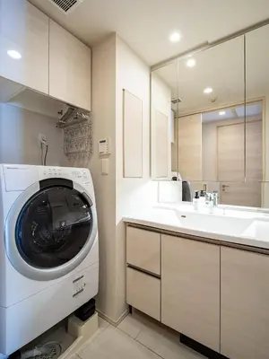 a washing machine in a bathroom with a sink at Section L Residence Shibuya in Tokyo