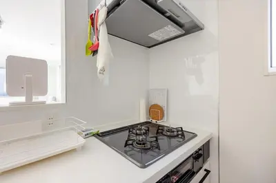 a kitchen with a stove and a sink at Ikebukuro 3 Chome in Tokyo