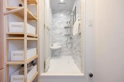 a bathroom with a shower and a toilet and a sink at Ikebukuro 3 Chome in Tokyo