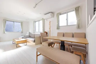 a living room with a table and chairs at Ikebukuro 3 Chome in Tokyo