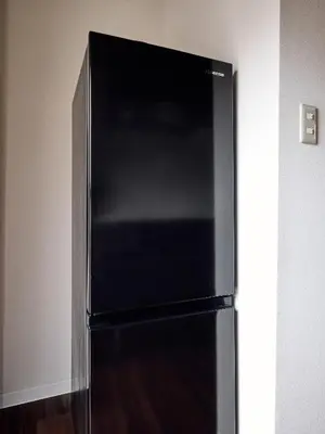 a black refrigerator in the corner of a room at asanagi in Tokyo